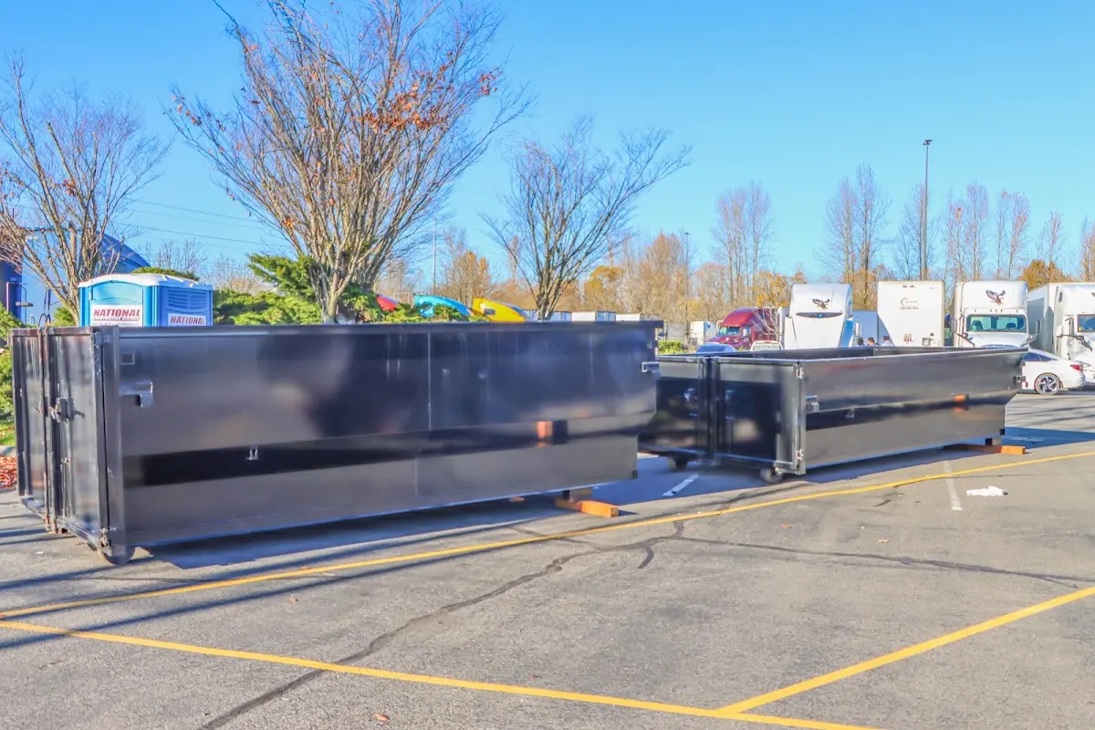 Professional dumpster rental service with roll-off container on residential driveway in Quakertown